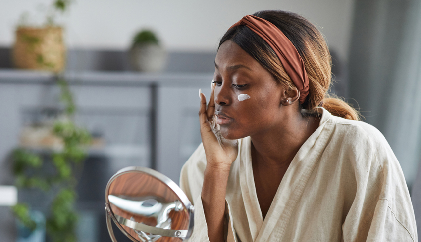 a woman applying eye cream